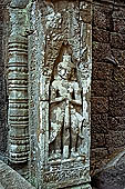 Ta Prohm temple - devatas sculpted on the gallery walls 